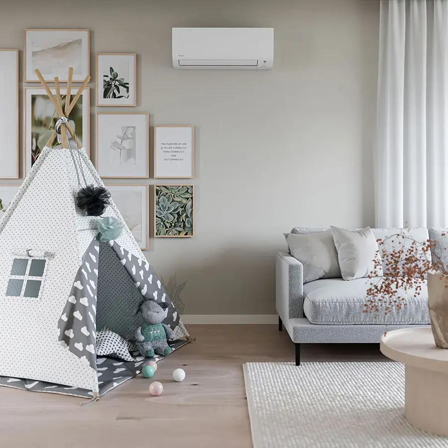 Daikin Moskus heat pump mounted on the wall of a bright Nordic living room