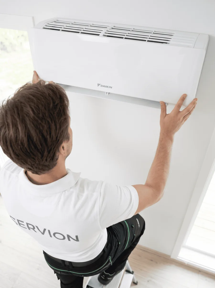 Servion technician mounting the indoor unit on the wall